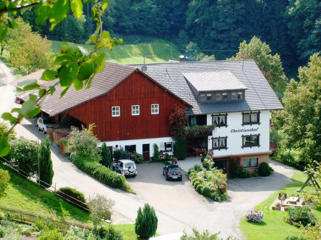 an aerial view of a large red and white barn at Christianshof in Oppenau
