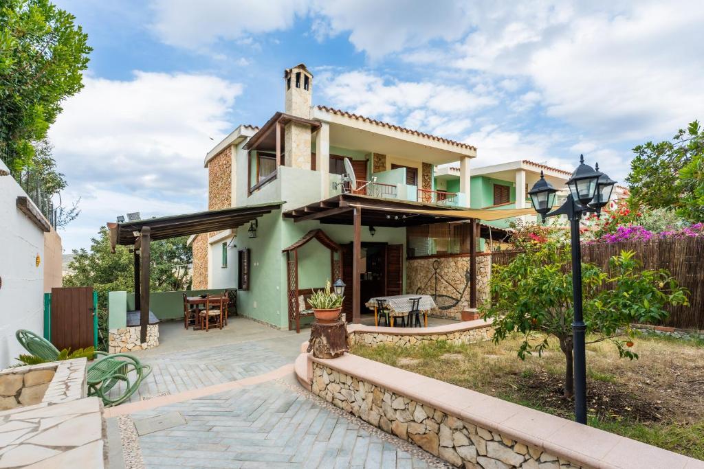 a house with a patio in front of it at Villa Alice in Villasimius
