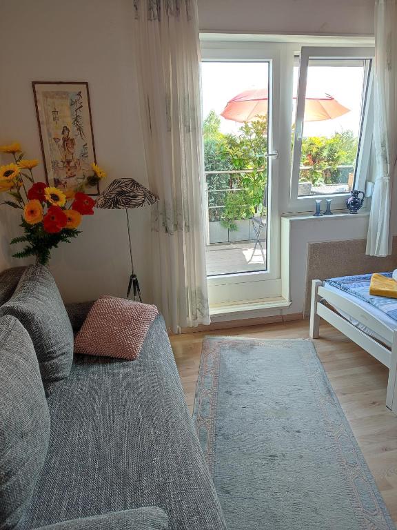 a living room with a couch and a window at B und E Röck in Meckenbeuren