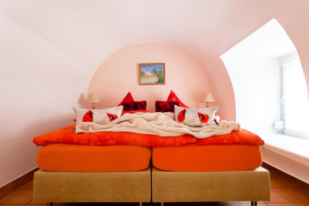 a bedroom with a bed with red pillows at Ferienwohnung Mengeler in Freiburg im Breisgau
