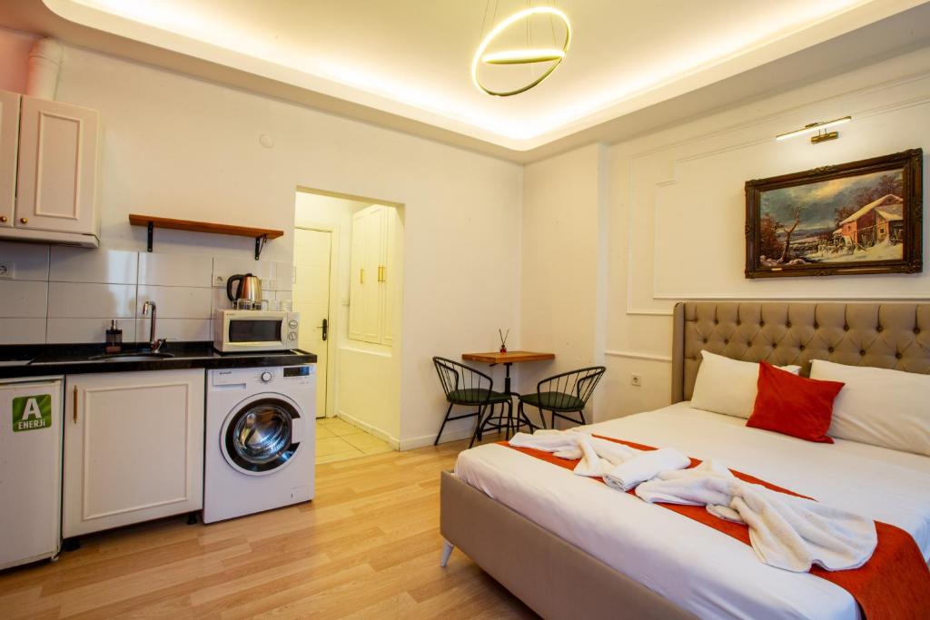 a bedroom with a bed and a washing machine at 1826 Heritage Suites in Taksim
