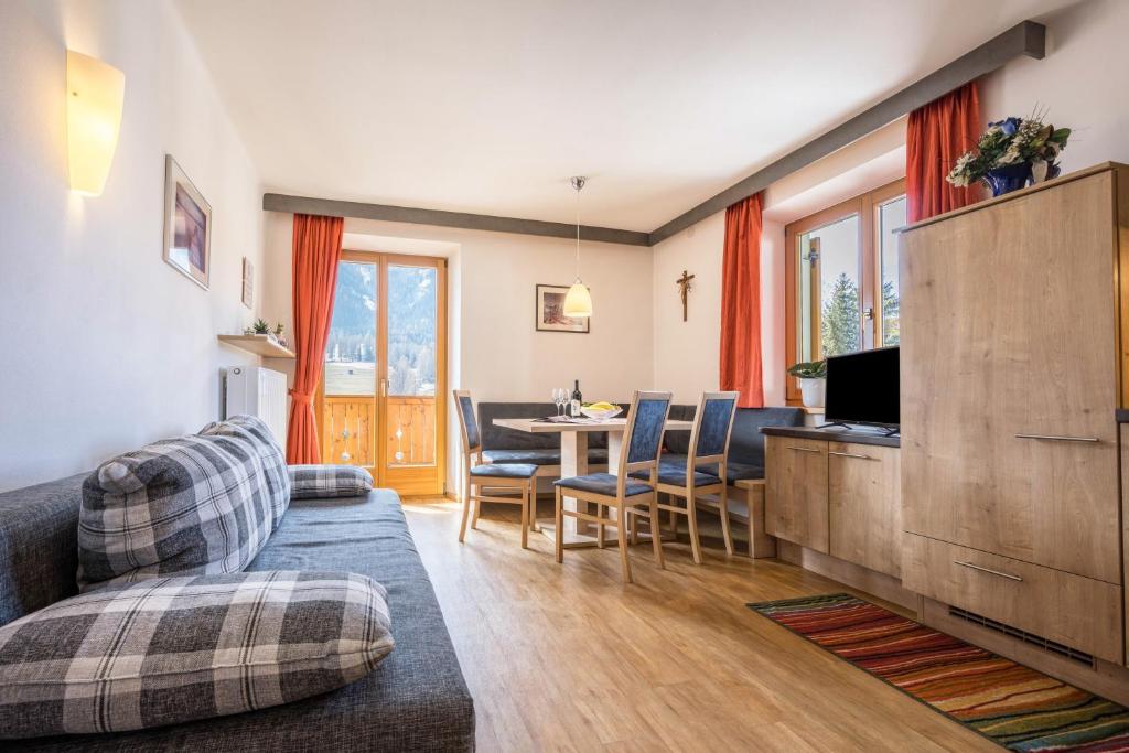 a living room with a couch and a table at Manuel's App Watschinger -Edelweiss in Sesto