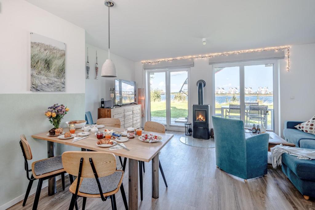 a living room with a table and chairs and a fireplace at An der Ostsee by Seeblick Ferien in Kappeln