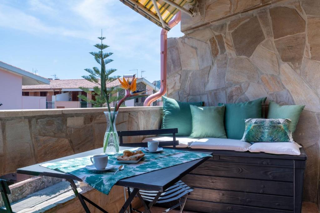 a patio with a table and a couch at Chelubirdi in Villasimius