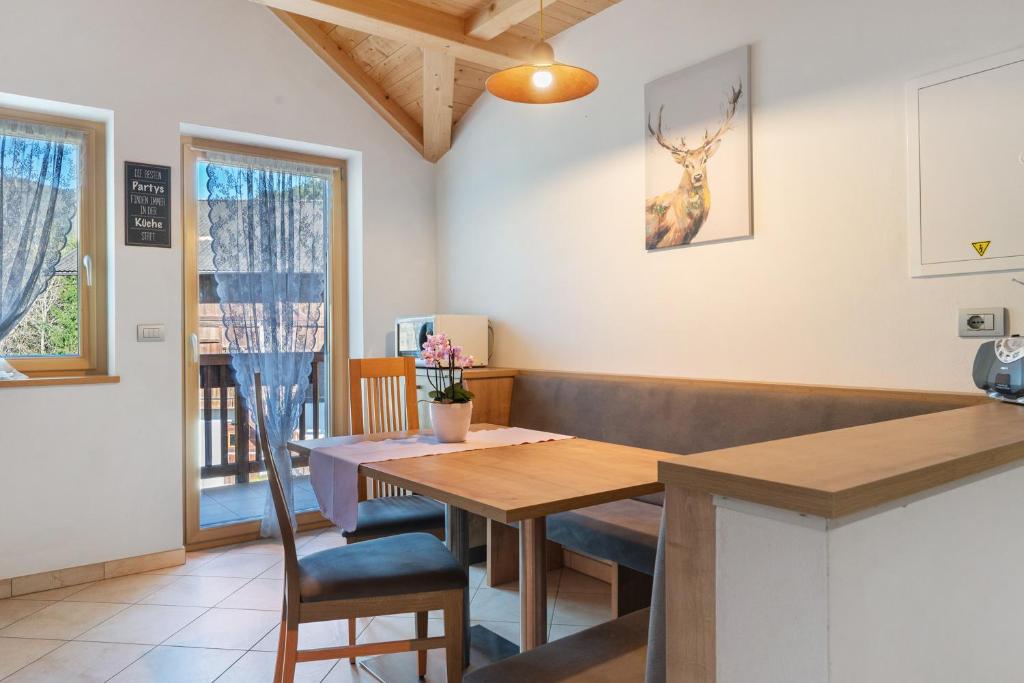 a dining room with a table and chairs at Kohlerhof Apartment in San Genesio Atesino