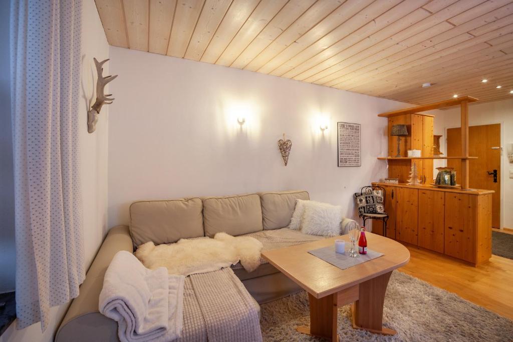 a living room with a couch and a table at Fewo in Urspring am Lechstausee in Steingädele