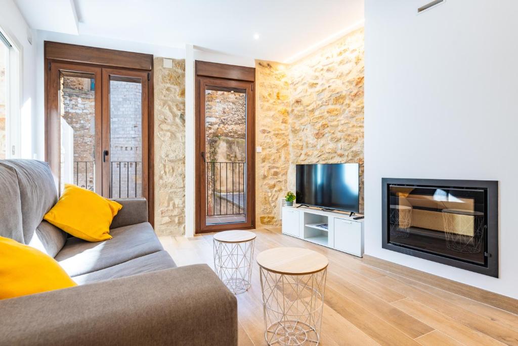 a living room with a couch and a fireplace at Casa del Campanar in Traiguera