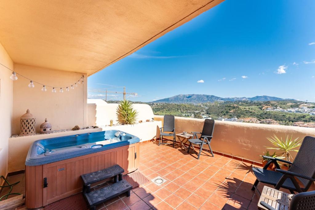 a hot tub on the balcony of a house at Las Terrazas in La Cala de Mijas