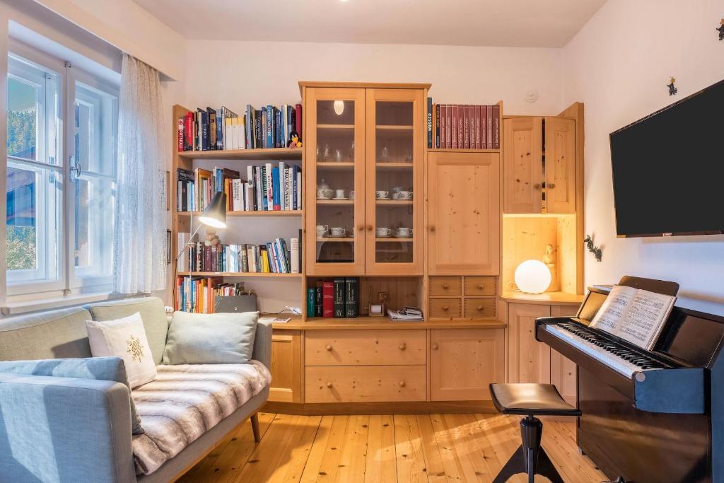 a living room with a piano and a couch at Ferienhaus Fingerhut in Eggen
