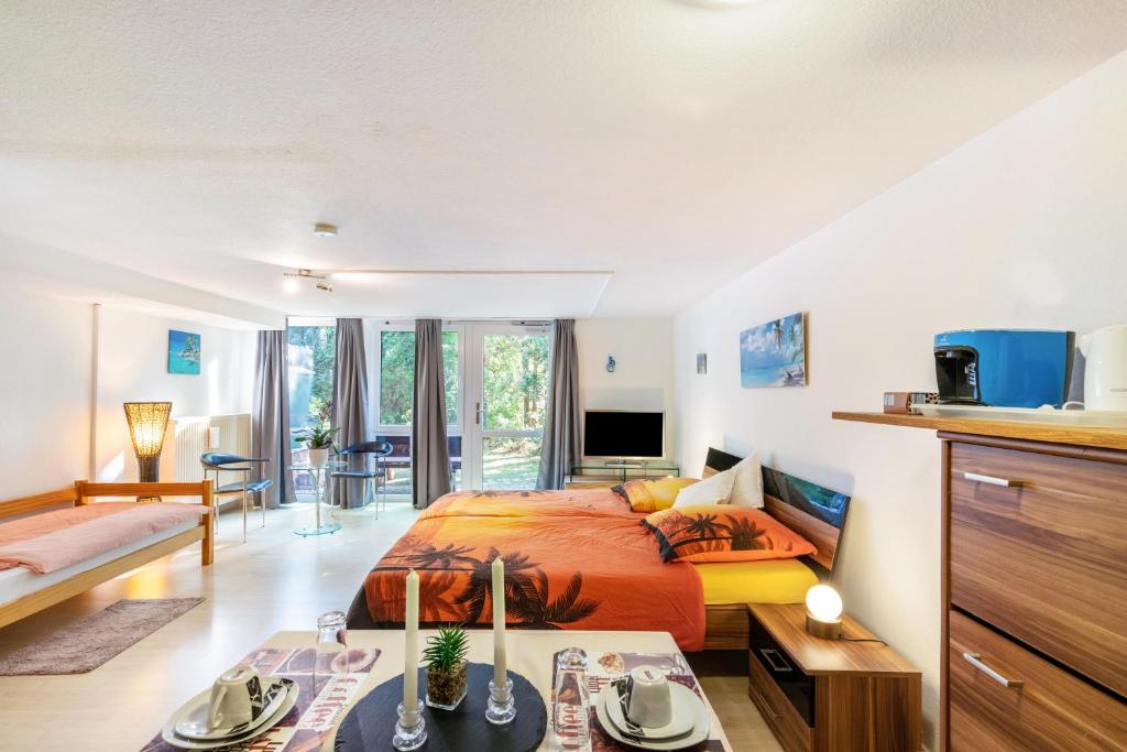 a bedroom with a king sized bed and a living room at Spessartruhe in Linsengericht