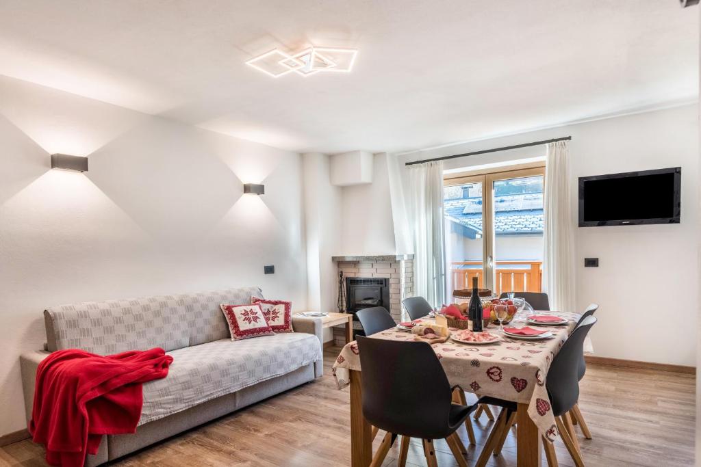 a living room with a table and a couch at Condominio Lucia 7 Pinzolo in Pinzolo