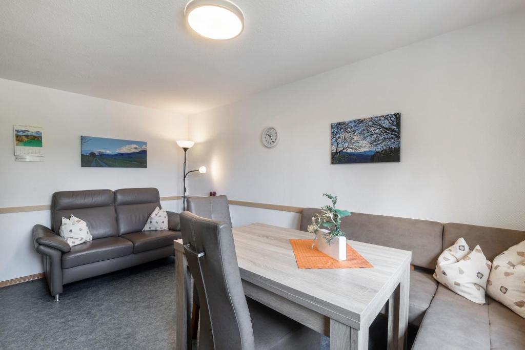 a living room with a table and a couch at Ferienwohnung Hacke in Schmallenberg