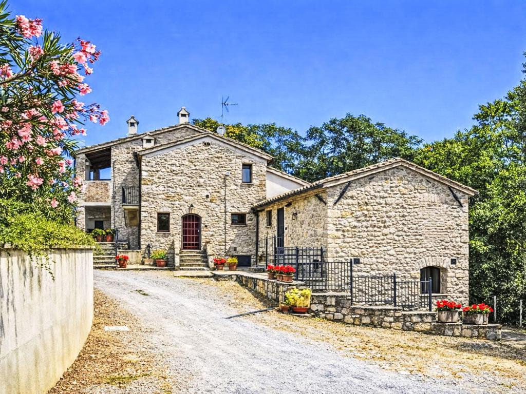 a stone house with a gate and a driveway at Apartment Cotoneaster by Interhome in Perugia