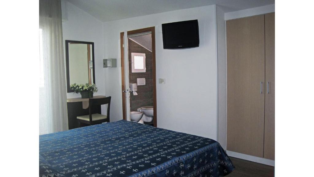 Postel nebo postele na pokoji v ubytování Hotel Sorriso - molto più di una stella