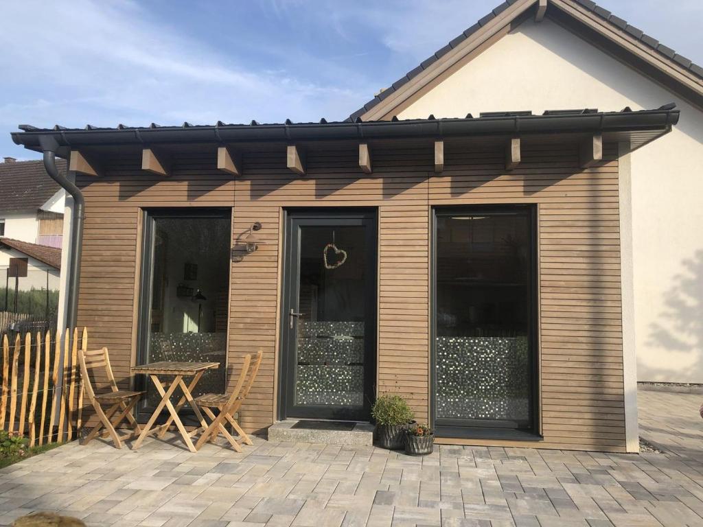 a house with a patio with a table and chairs at Ferienwohnung Haas Oberschopfheim in Friesenheim