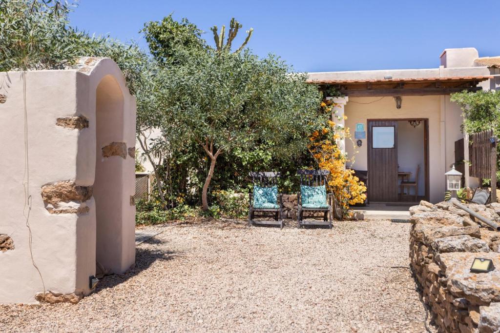 two chairs sitting in front of a house at Can Mussenya 1 in Illes Balears