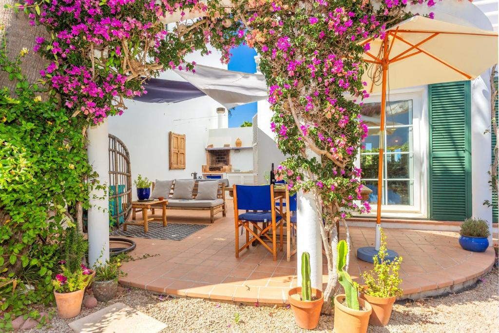 a patio with bougainvillea at Aloes in Sa Caleta