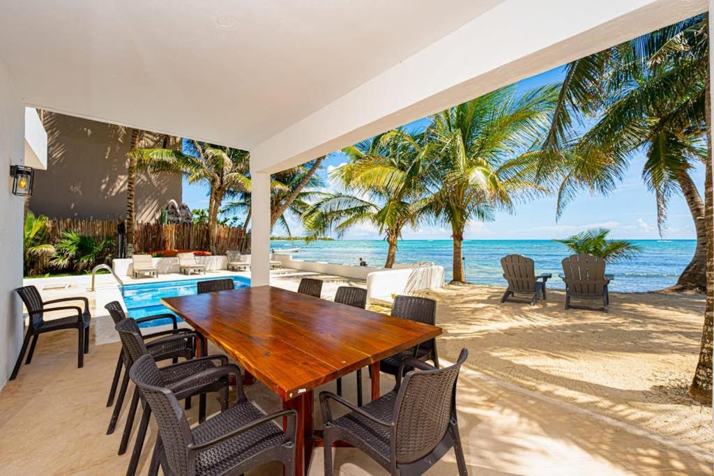 a dining room with a table and chairs on the beach at Oceanfront home with beach access pool balconies & waterfront hammocks - Villa Sol in Tulum