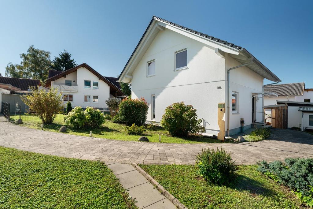 a white house with a driveway at Haus Langer in Oberkirch
