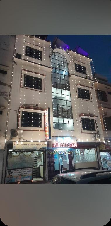 a large white building with lights in front of it at Hotel prayag with ev car station 7,4kw in Nāthdwāra