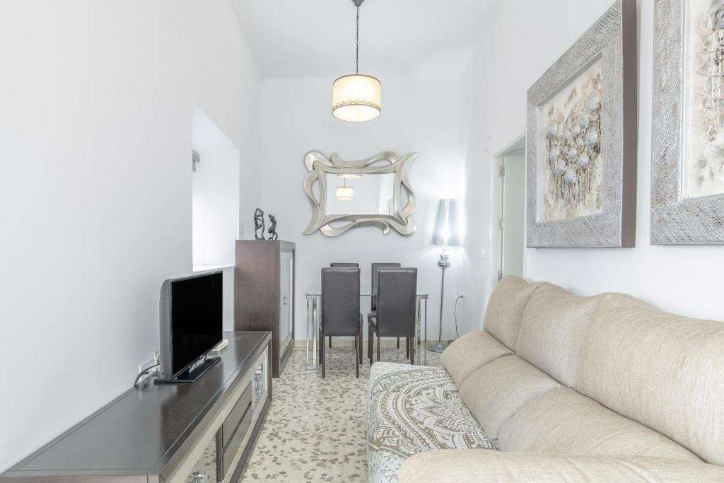 a living room with a couch and a tv at Casa Pepa in Barbate