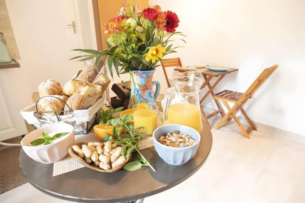 a table topped with a tray of food and flowers at Lyon Mon Amour Bed and Breakfast in Lyon