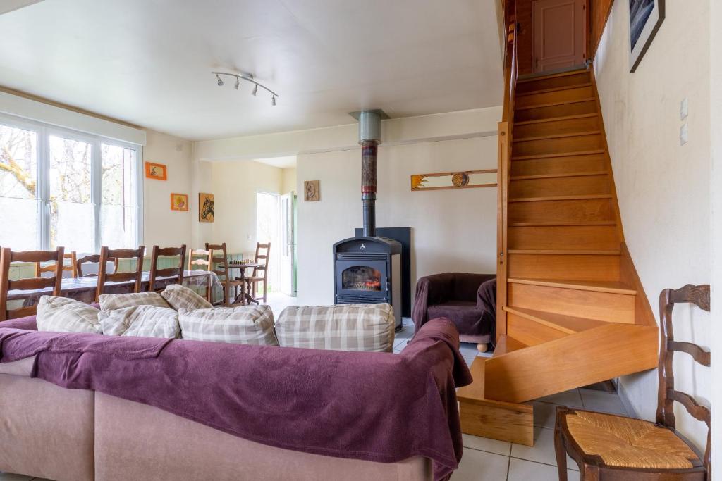 a living room with a couch and a wood stove at Gite Du Dombief in La Chaux-du-Dombief