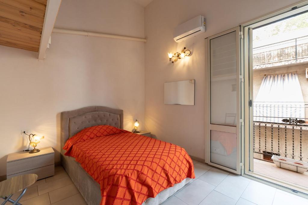 a bedroom with a bed and a large window at Seacastle Sicily in Castellammare del Golfo