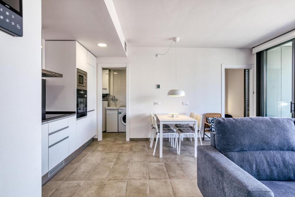 a living room with a couch and a table at Murtra Apartment in Roses