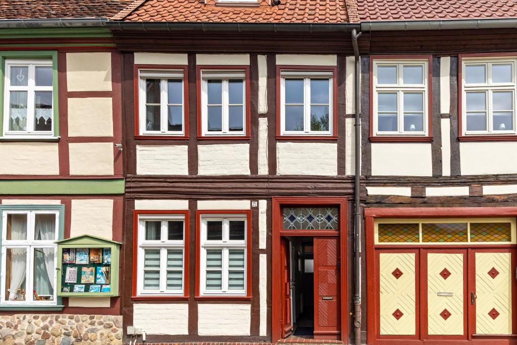 a building with red doors and windows at Ferienhaus Salzwedel in Salzwedel