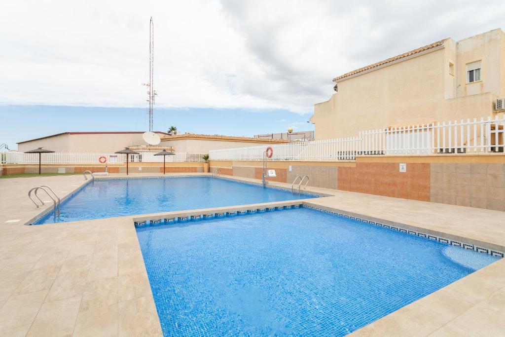 a large swimming pool in front of a building at Bungalow 145 in Santa Pola