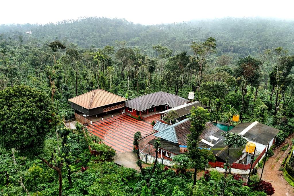 an aerial view of a house in the forest at Coffee Crown Homestay - 1km to Falls, Estate, Home Food in Sakleshpur