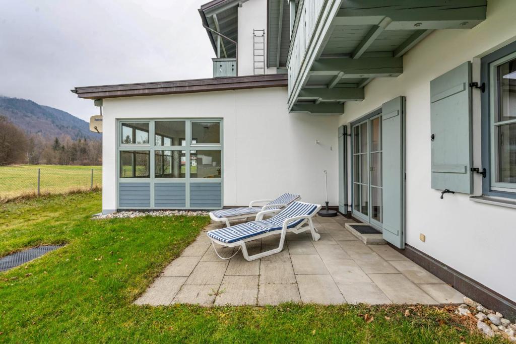 a patio with a bench on the side of a house at Fewo Brünnstein - Nr 11 Pool, Sauna in Oberaudorf