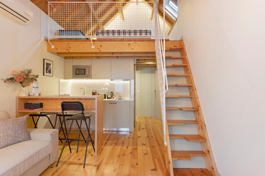 a room with a loft bed and a kitchen at Orange Apartments B in Porto