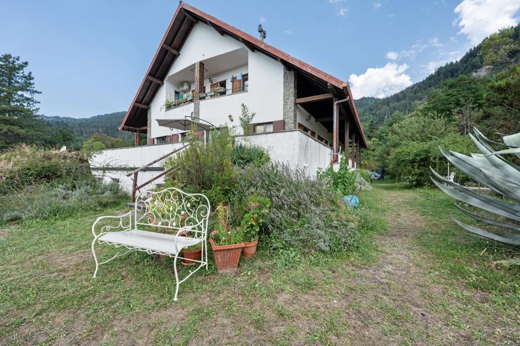 a white chair sitting in front of a house at Alta Via Ligure - La Squazza in Bertigaro