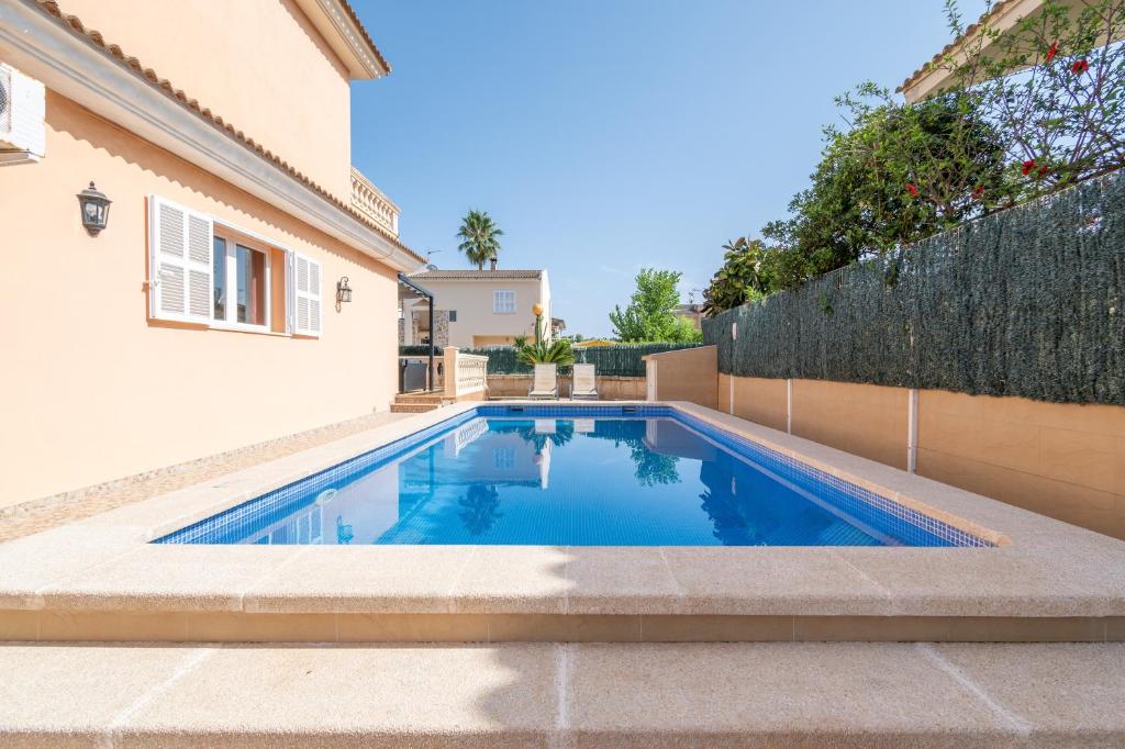 a swimming pool in the backyard of a house at Villa Gaviota in Muro