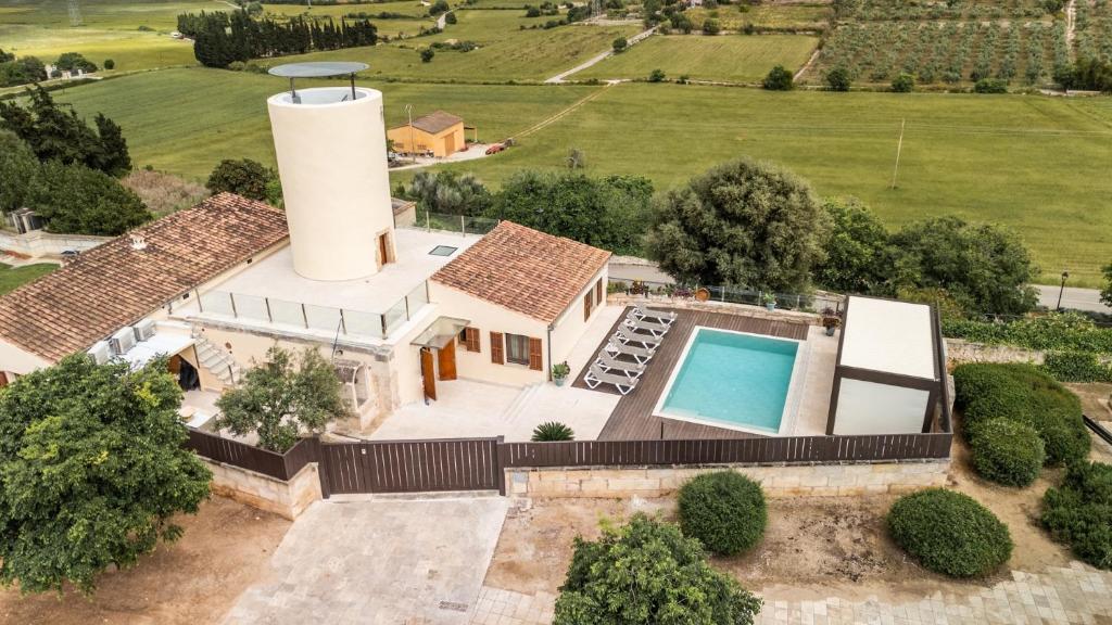 an aerial view of a mansion with a water tower at Moli De Can Cristan in Muro