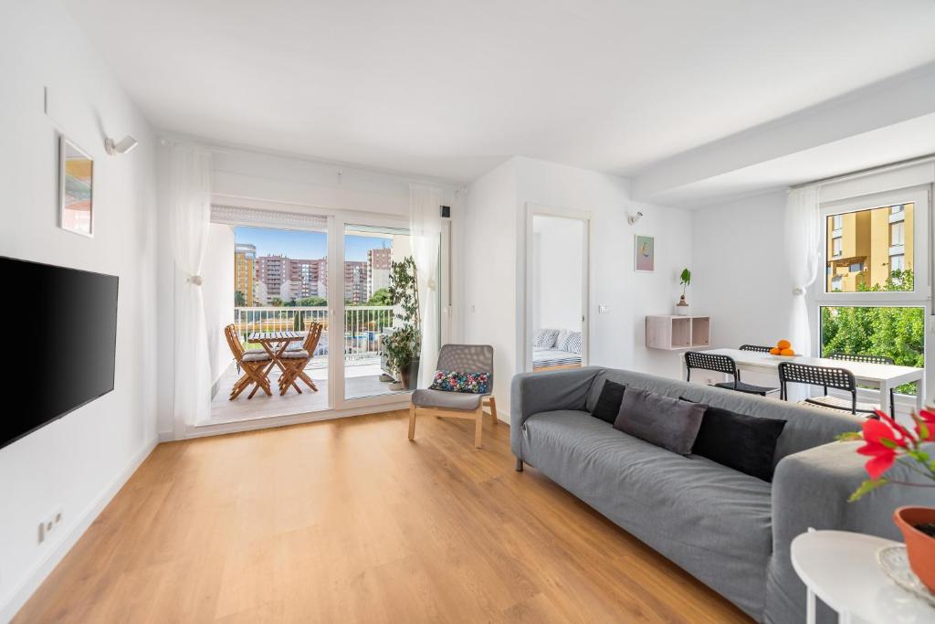 a living room with a couch and a television at Lopimar Playa in Canet de Berenguer