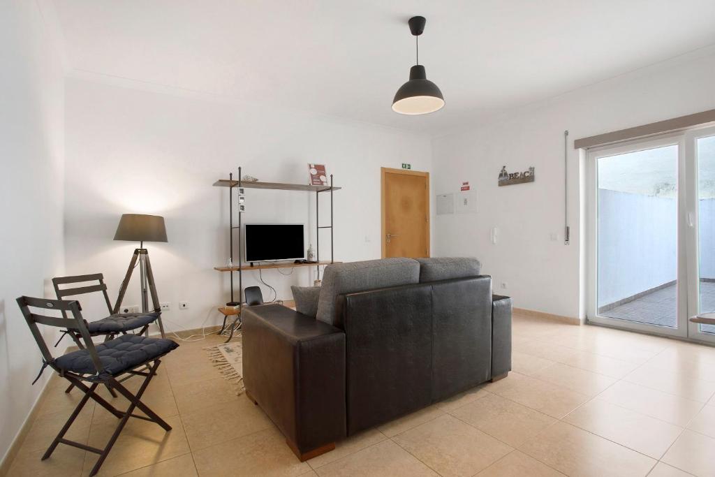 a living room with a couch and a chair and a television at A O - Tina House Ferrel in Ferrel