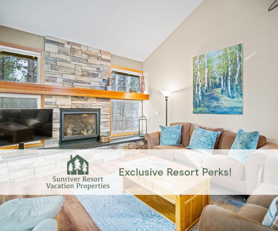 a living room with a couch and a fireplace at 28 Quelah Condo in Sunriver