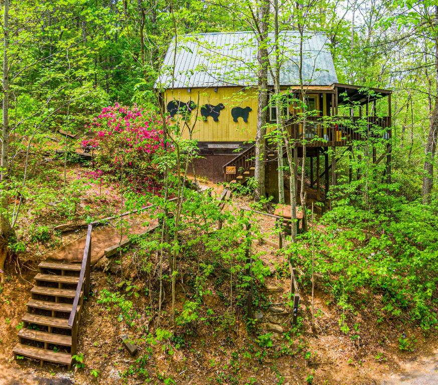 a house in the woods with stairs leading to it at Riverview Cabin in Helen