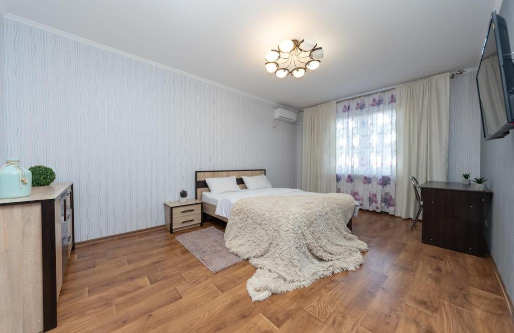 a bedroom with a bed and a television in it at Apartment near VDNG 18010 in Kyiv