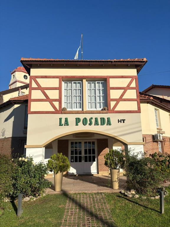 a building with a sign that reads la costada at La Posada in Merlo