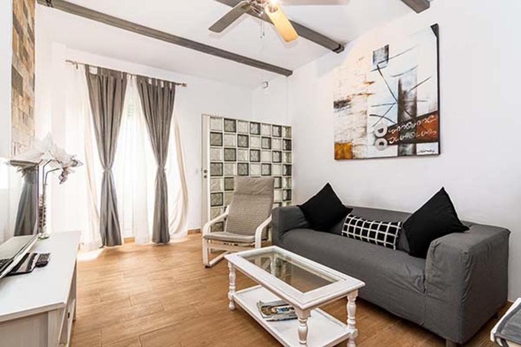 a living room with a couch and a table at Casa Jimena in Vejer de la Frontera