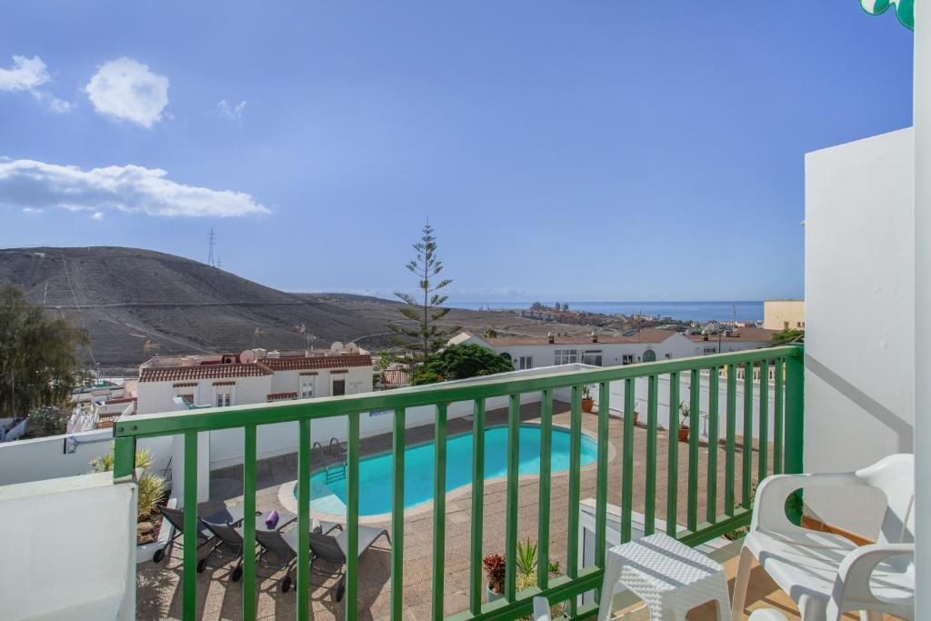 a balcony with a view of a swimming pool at Casa Carmelo in Patalavaca