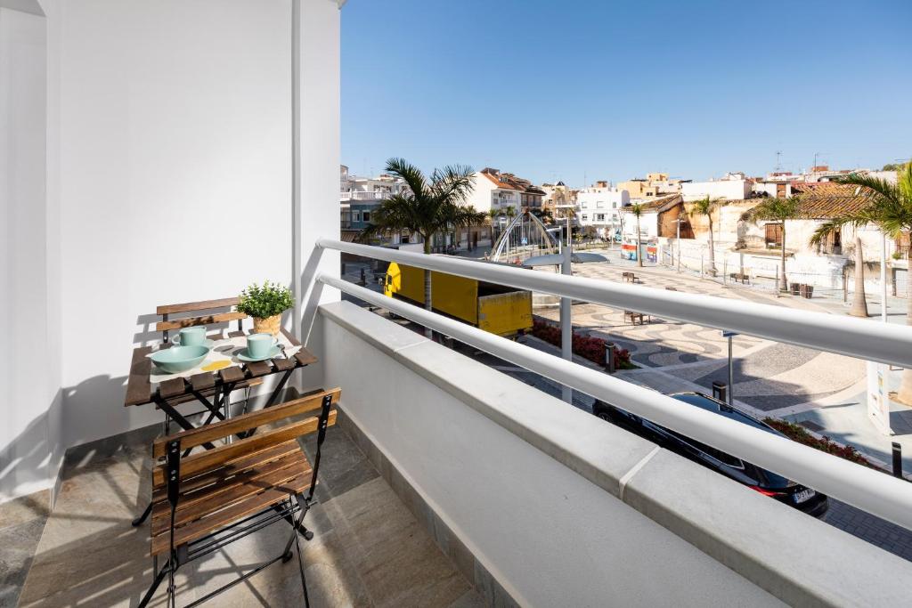 a balcony with a table and a view of the city at Capricho Torre del mar in Torre del Mar