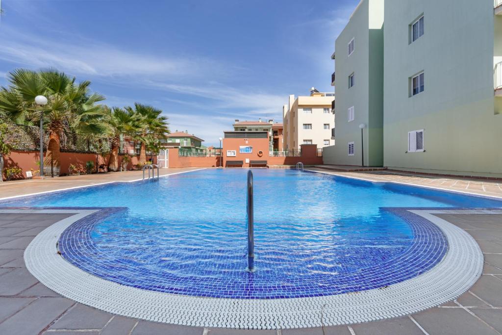 a large swimming pool in the middle of a building at Apartamento Gabriela in Candelaria