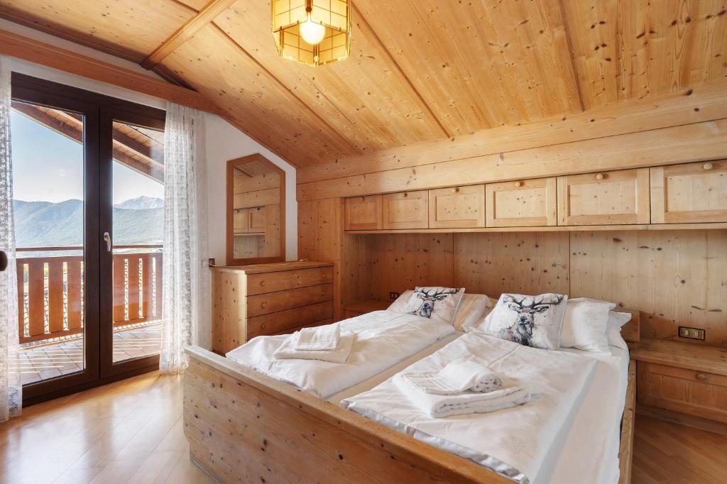 a bedroom with a bed in a wooden room at Apartment Holzsuite in Fondo