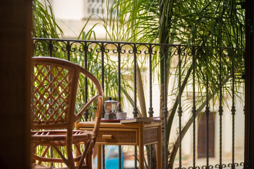 a table and chair on a balcony with a plant at Monolocale 900 in Racale