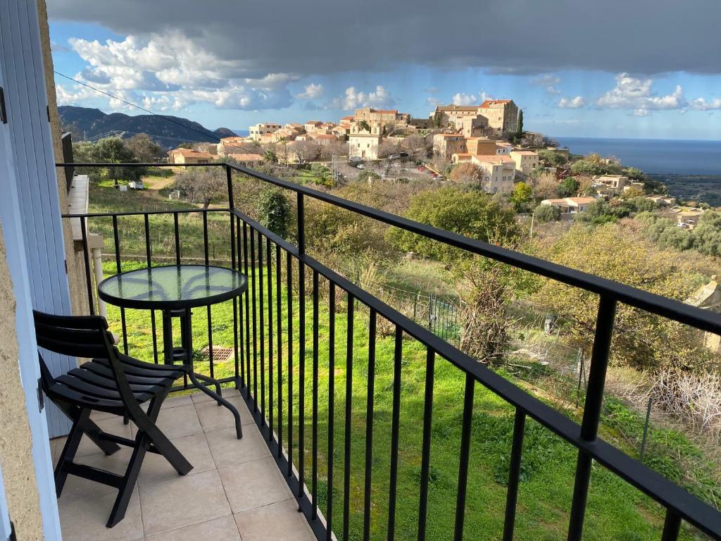 a balcony with a table and chair and a view at Villa Pigna in Pigna